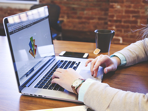 Close up of person working on laptop